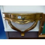 A reproduction gilt wall mounted console