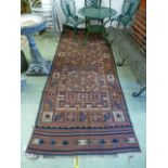 A handwoven Persian kilim, the red groun