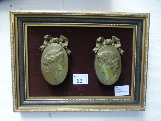 A framed pair of gilt metal plaques of f