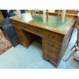 A yew effect twin pedestal desk with a g