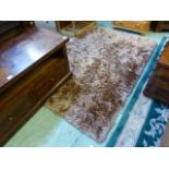 A fluffy rectangular brown rug