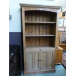 A waxed pine bookcase having open storag