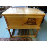 A golden oak hinged top cabinet with sla