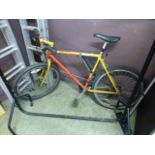 A gents red and yellow mountain bike