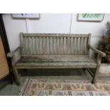 A weathered teak garden bench