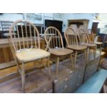 Four spindle back chairs together with a
