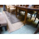 A natural wool woven rug together with a