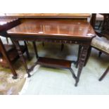 An Edwardian walnut side table with unde