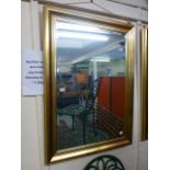 A modern rectangular gilt framed oval gl