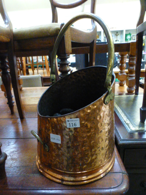 A brass and copper effect coal bin