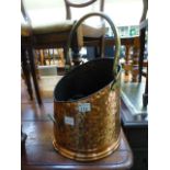 A brass and copper effect coal bin