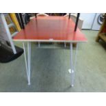 A 1950s red Formica dinning table having