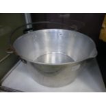 A large aluminium jam pan with metal han