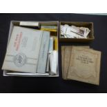 A box containing cigarette card albums,