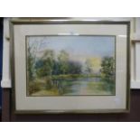 A framed and glazed pastel of a lake sce