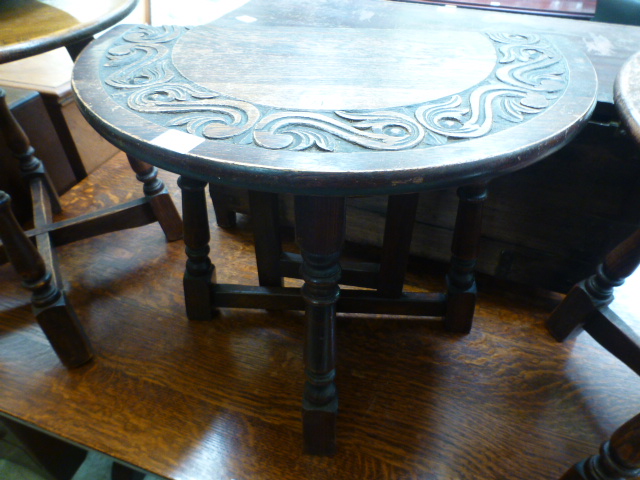 A carved topped circular drop-leaf occas