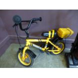 A child's yellow Apollo bicycle