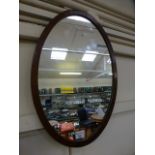 A Georgian style oval mahogany mirror