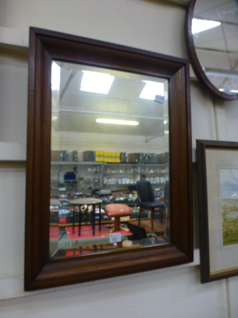 A mahogany framed bevel glass wall mirro