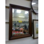 A mahogany framed bevel glass wall mirro