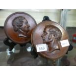 A pair of carved oak plaques depicting R