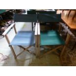 A pair of green upholstered folding dire