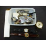 A plastic carton of assorted watches etc