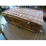 A wicker picnic basket with contents