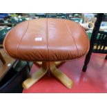 A modern tan and leather footstool