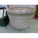 A weathered circular stoneware garden pl