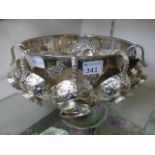 A silver plated punch bowl with cups