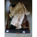 A tray containing fur stoles, child's co