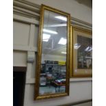 A rectangular ornate gilt framed wall mi