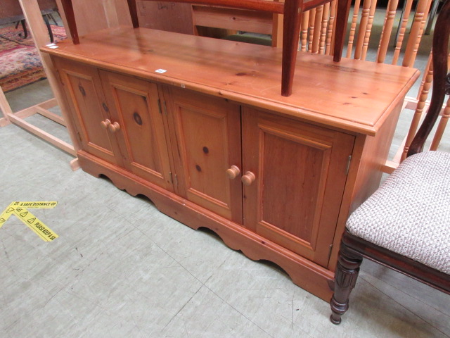 A modern pine four door cabinet