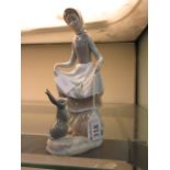 A Lladro figure of a lady with a bunny