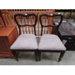 A pair of mahogany balloon back dining c