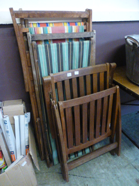 Two folding beech style deck chairs toge