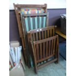 Two folding beech style deck chairs toge