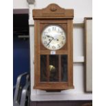 An oak cased drop-dial wall clock