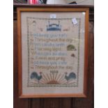 A framed and glazed sampler dated 1928