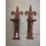 A pair of cast iron wall sconces