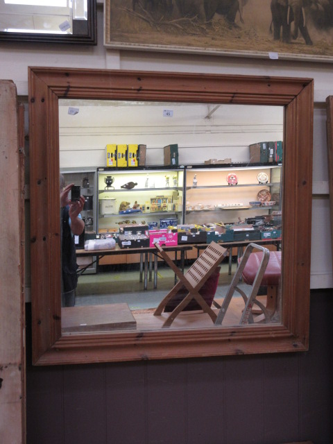 A waxed pine framed mirror