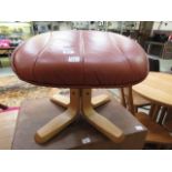 A modern tan and leather footstool