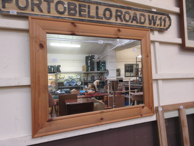 A waxed pine framed wall mirror