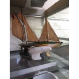 Three wooden model yachts