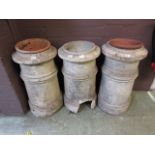 Three distressed chimney pots