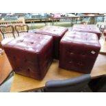 Four red leatherette upholstered stools