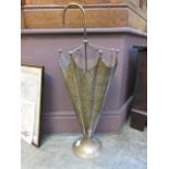 A brass umbrella stand in the form of a