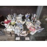 A collection of miniature Limoges teapot