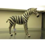 A papier mache model of a Zebra having l
